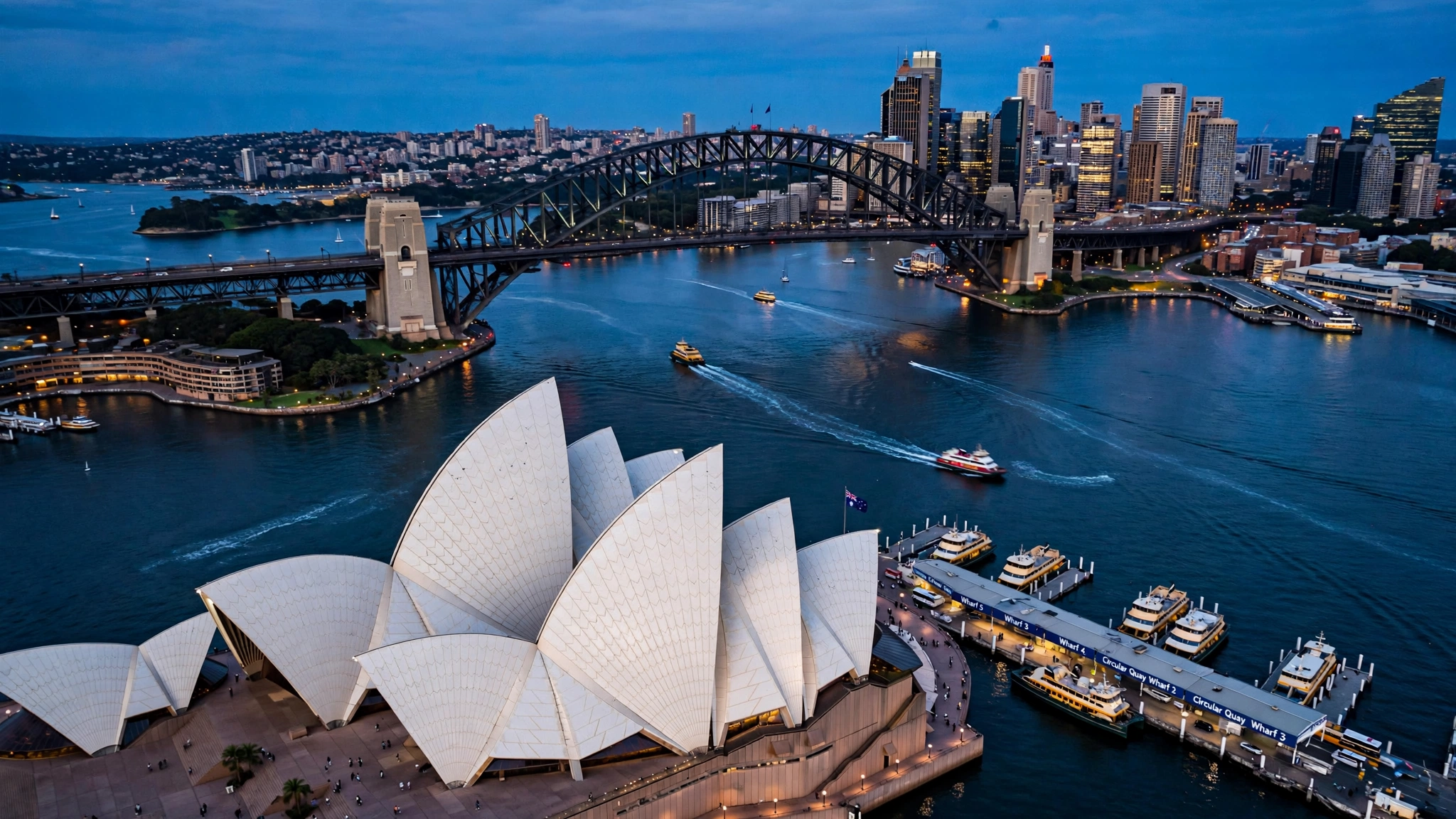 Sydney Opera House and Harbour Bridge across Sydney Harbour at dusk