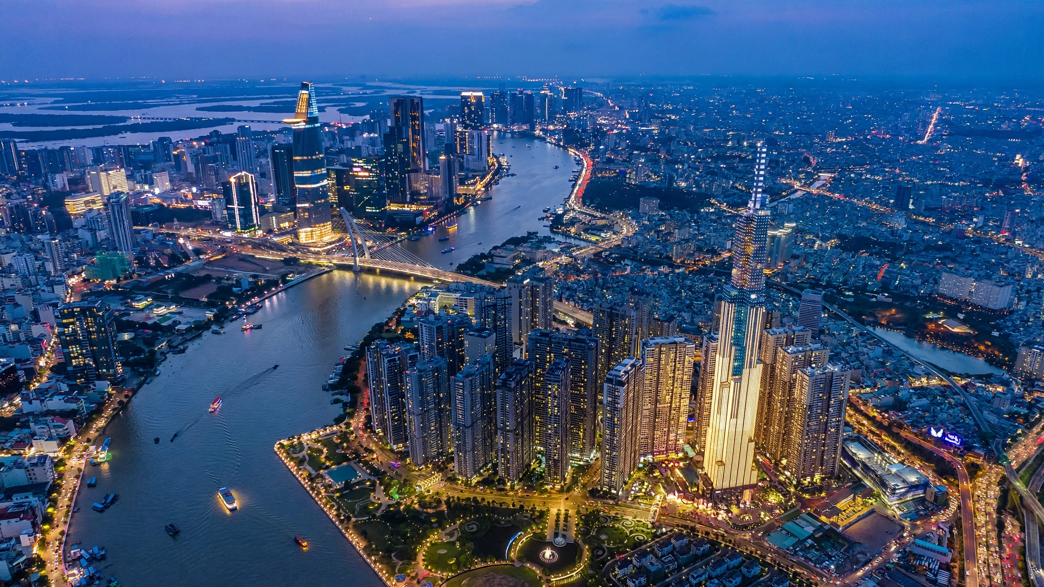 Ho Chi Minh City skyline over the Saigon River and Landmark 81 at blue hour