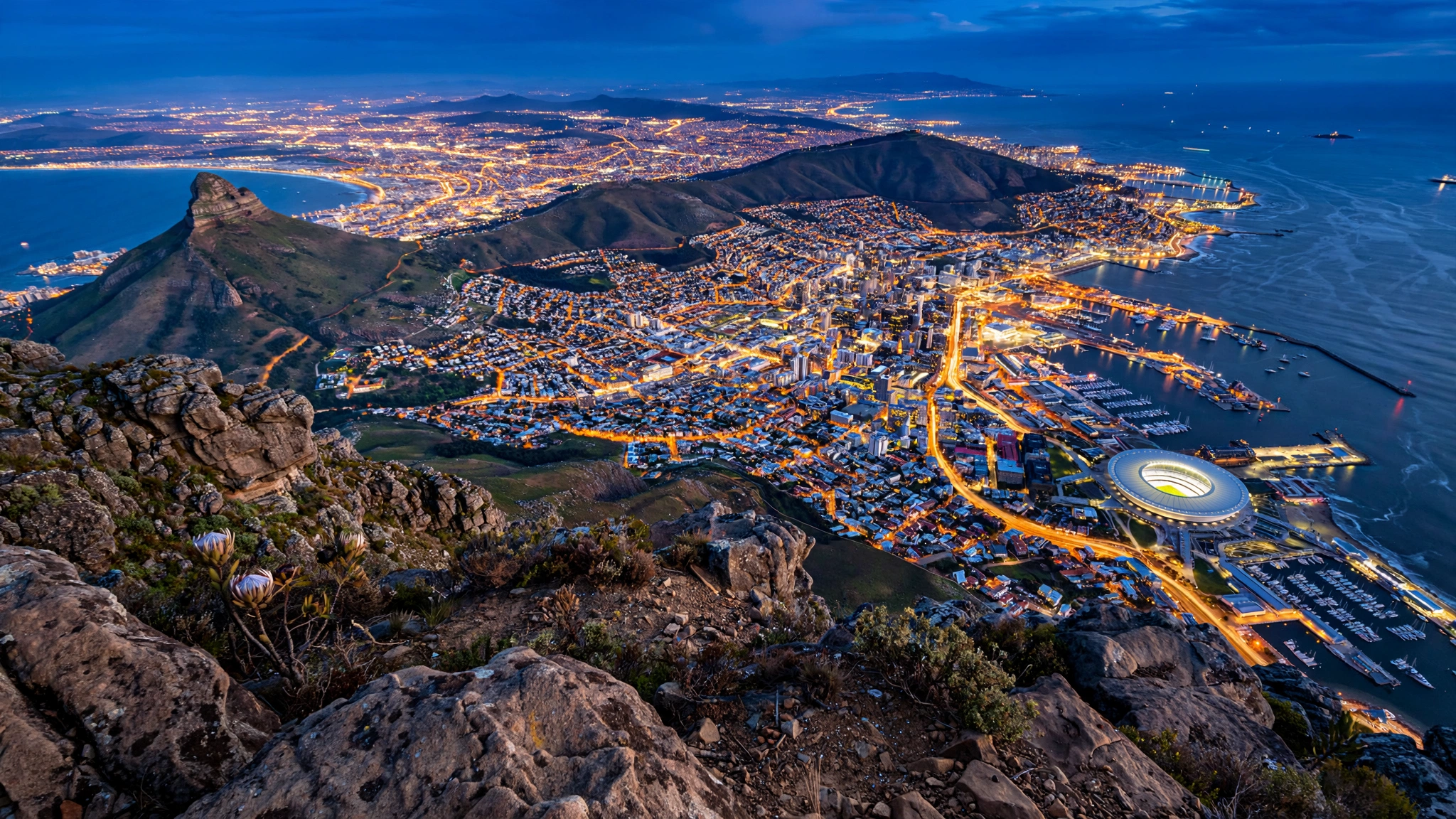 Cape Town seen from Table Mountain above the illuminated city and harbour at dusk